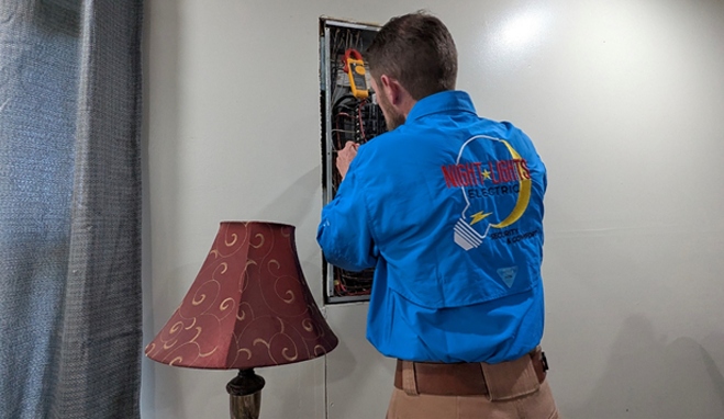 NightLightsElectric.com Stephen working on new electrical lines in a breaker box for a residential house.